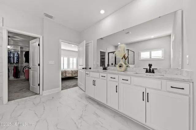 a spacious bathroom with a granite countertop sink mirror and shower