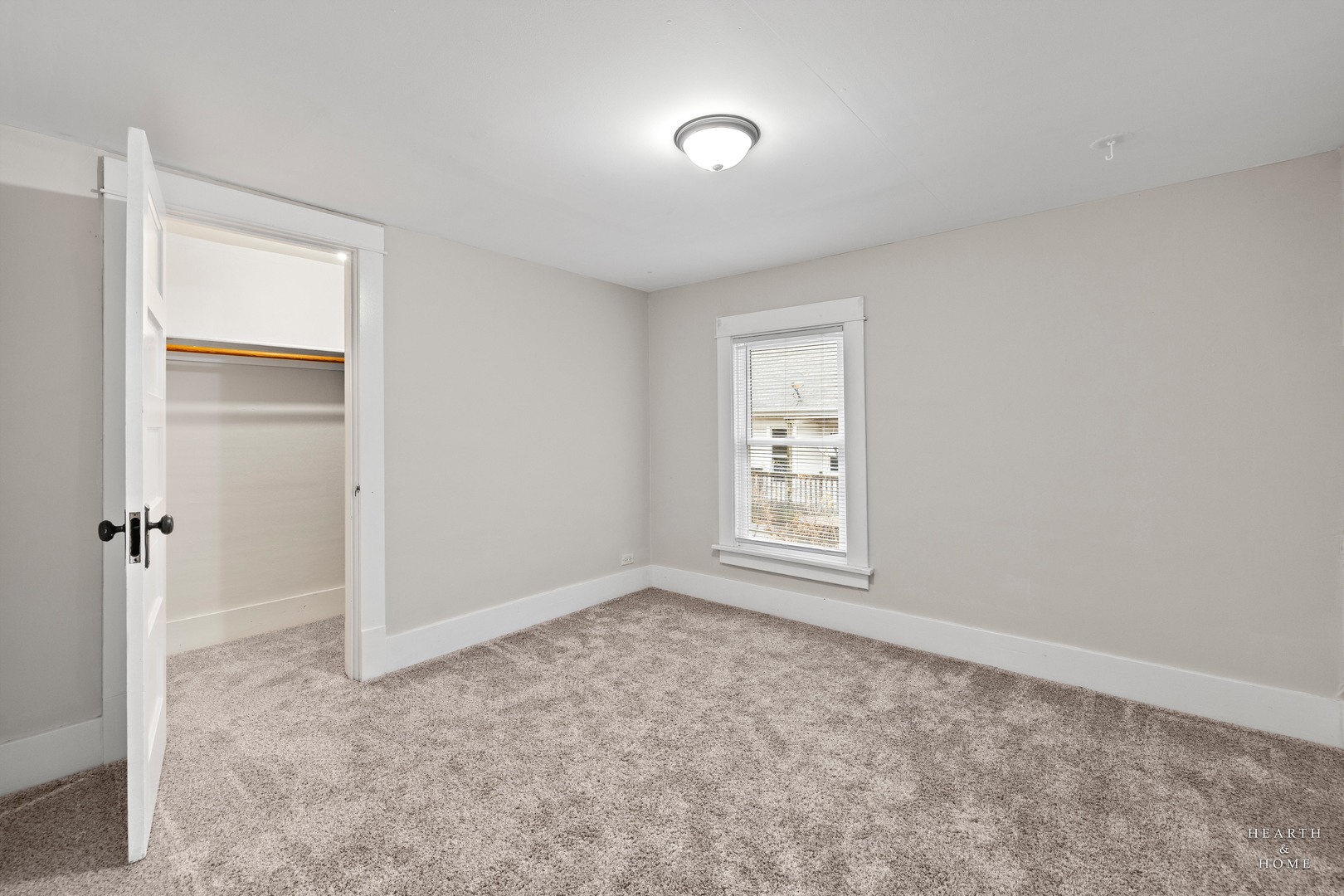 415 Dean Street, Unit 2 Woodstock, IL 60098 - Photo 13 of 21 an empty room with windows and closet