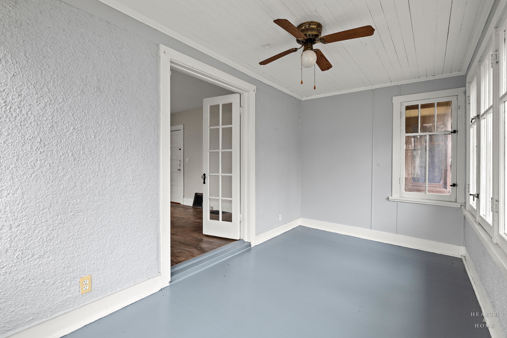 415 Dean Street, Unit 2 Woodstock, IL 60098 - Photo 4 of 21 an empty room with chandelier fan and windows