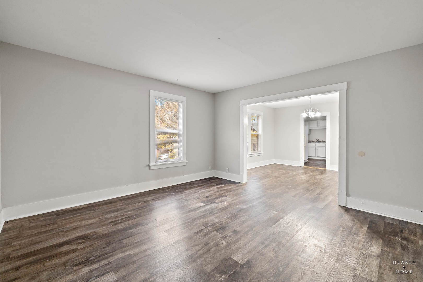 415 Dean Street, Unit 2 Woodstock, IL 60098 - Photo 9 of 21 a view of an empty room with wooden floor and a window
