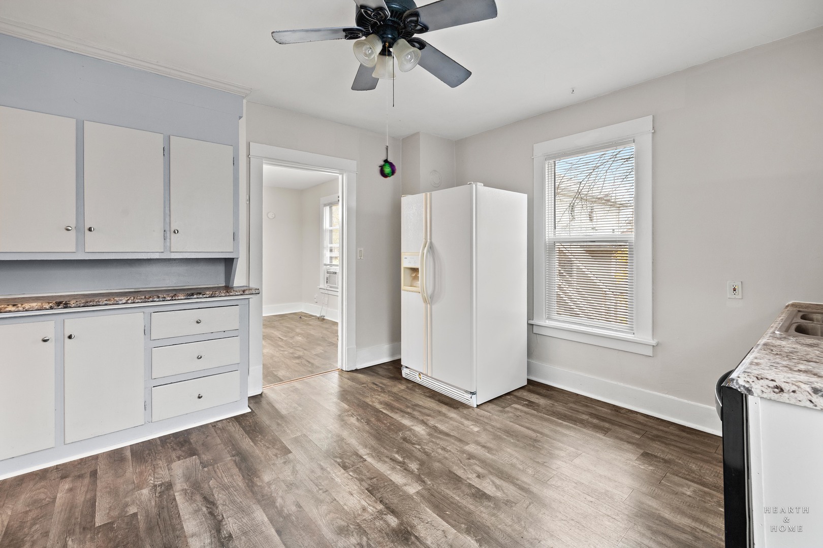 415 Dean Street, Unit 2 Woodstock, IL 60098 - Photo 10 of 21 a view of kitchen with granite countertop cabinets and window