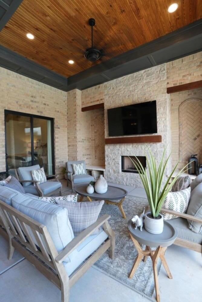 4101 149th Street Lubbock, TX 79423 - Photo 45 of 53 a living room with furniture a fireplace and a flat screen tv