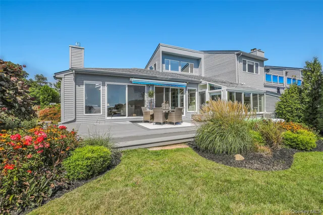a front view of a house with swimming pool having outdoor seating