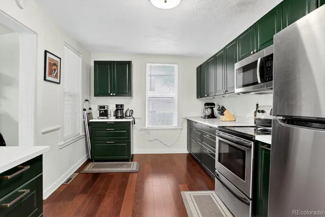 a kitchen with stainless steel appliances a stove microwave and cabinets
