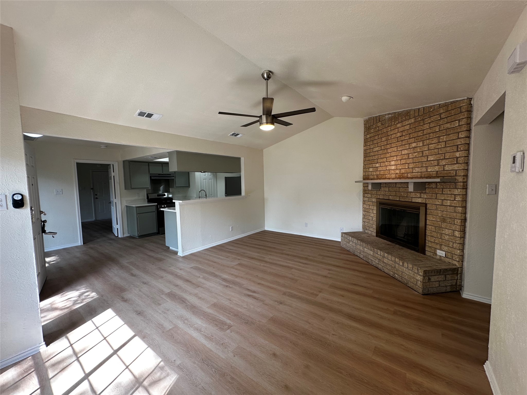 8809 Cainwood Lane Austin, TX 78729 - Photo 11 of 27 a view of a kitchen with a sink and a stove top oven