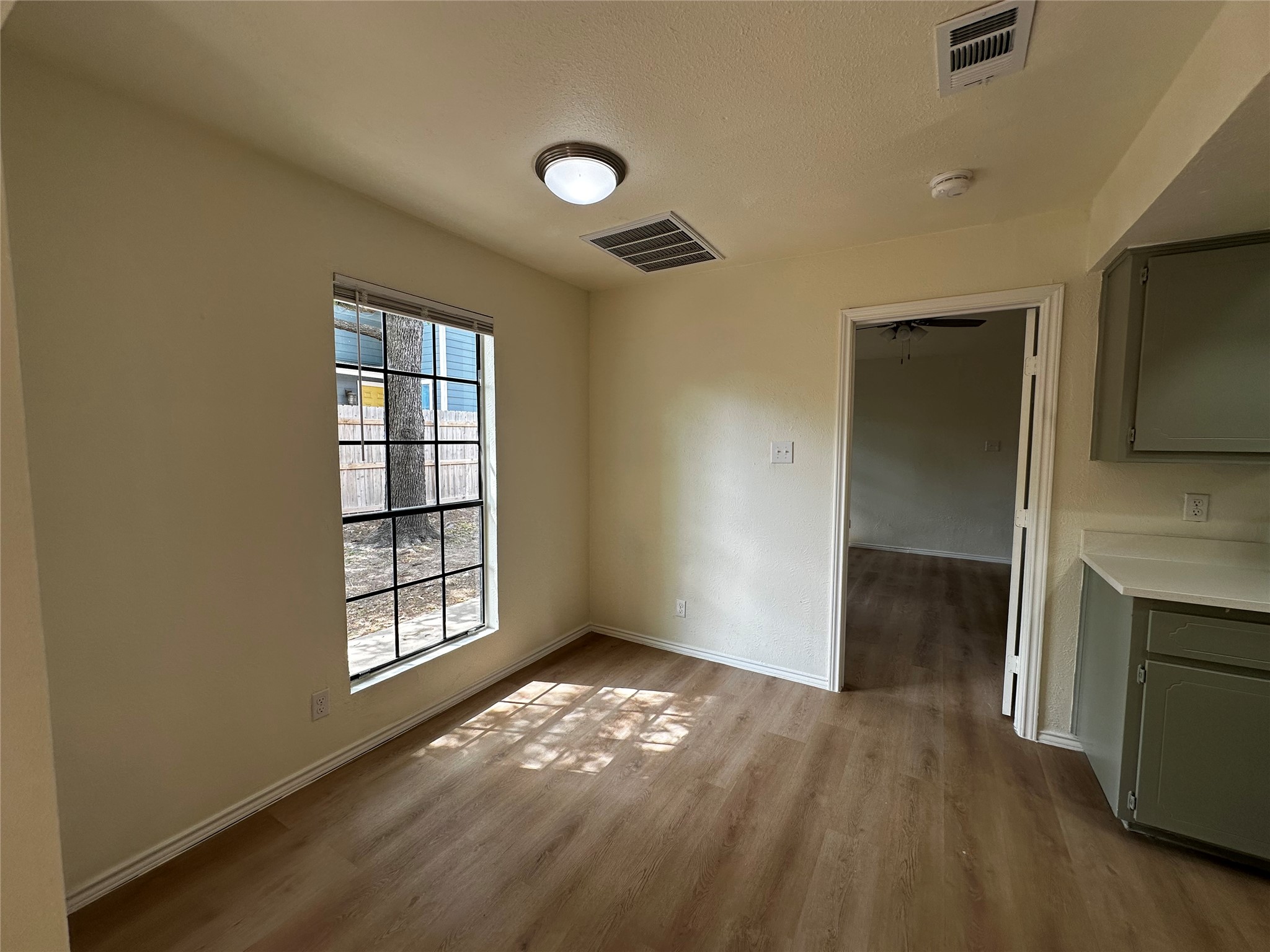 8809 Cainwood Lane Austin, TX 78729 - Photo 13 of 27 an empty room with windows and fireplace