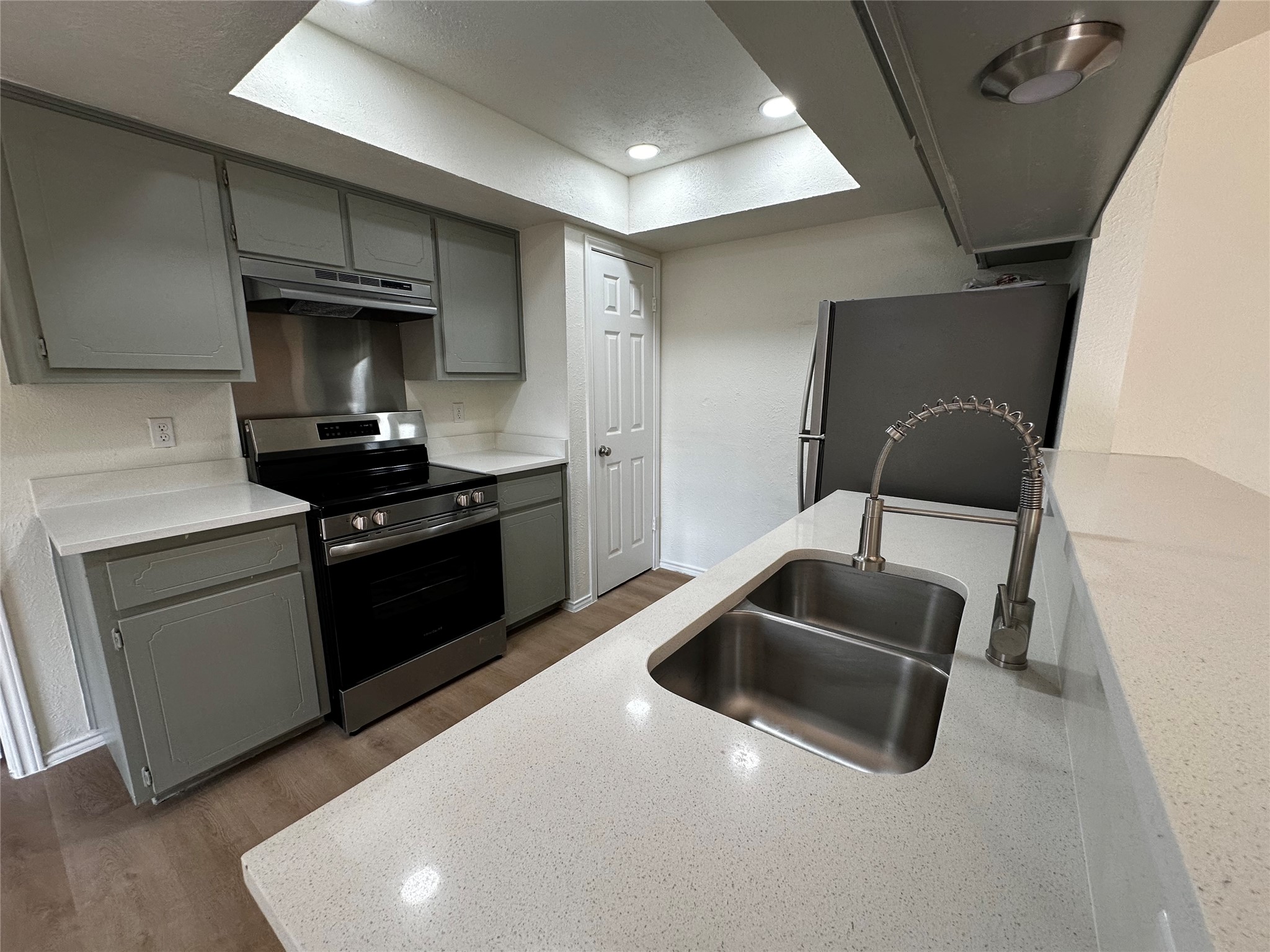 8809 Cainwood Lane Austin, TX 78729 - Photo 15 of 27 a kitchen with granite countertop a stove and a sink