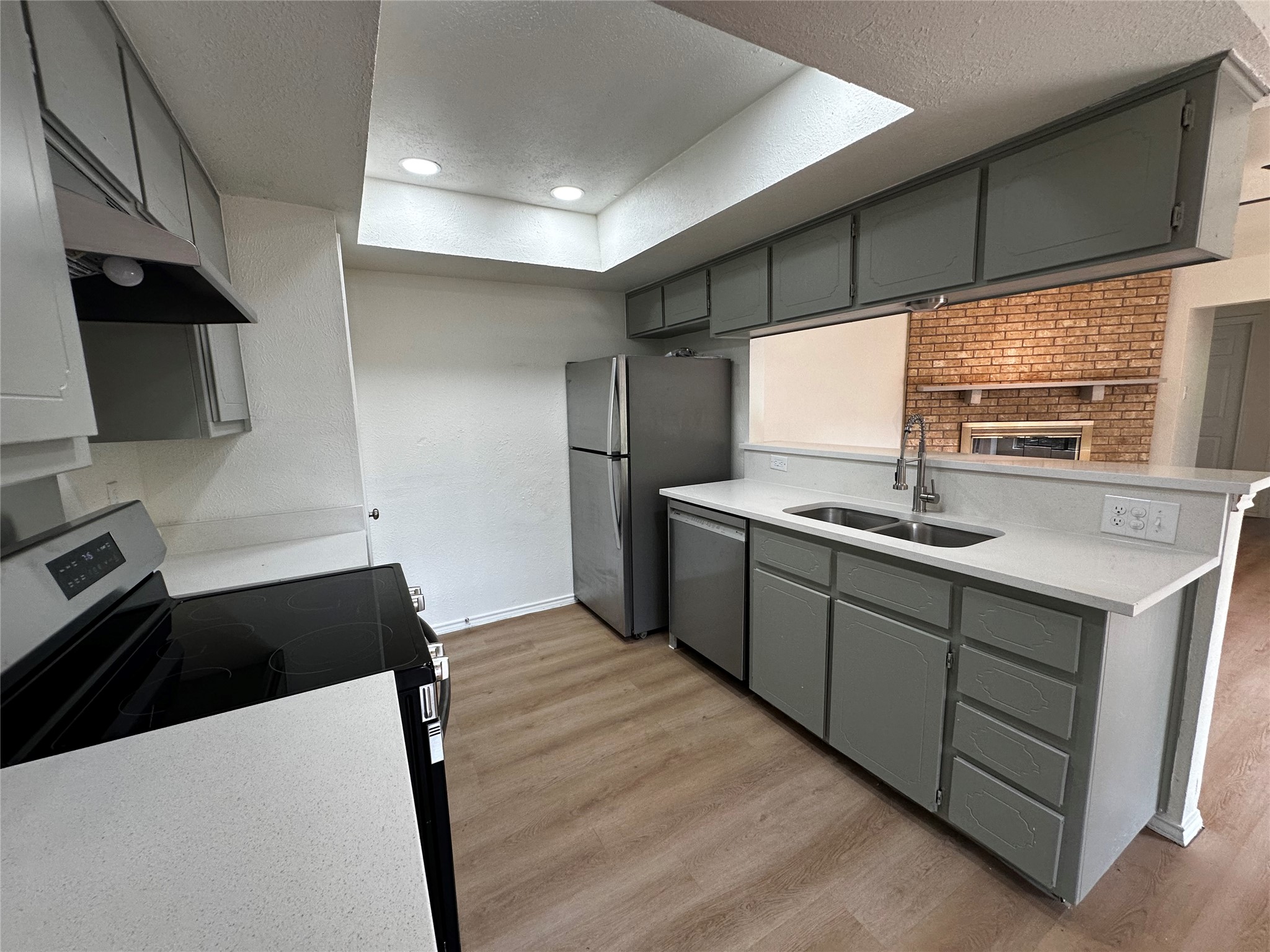 8809 Cainwood Lane Austin, TX 78729 - Photo 16 of 27 a kitchen with stainless steel appliances a sink stove and refrigerator