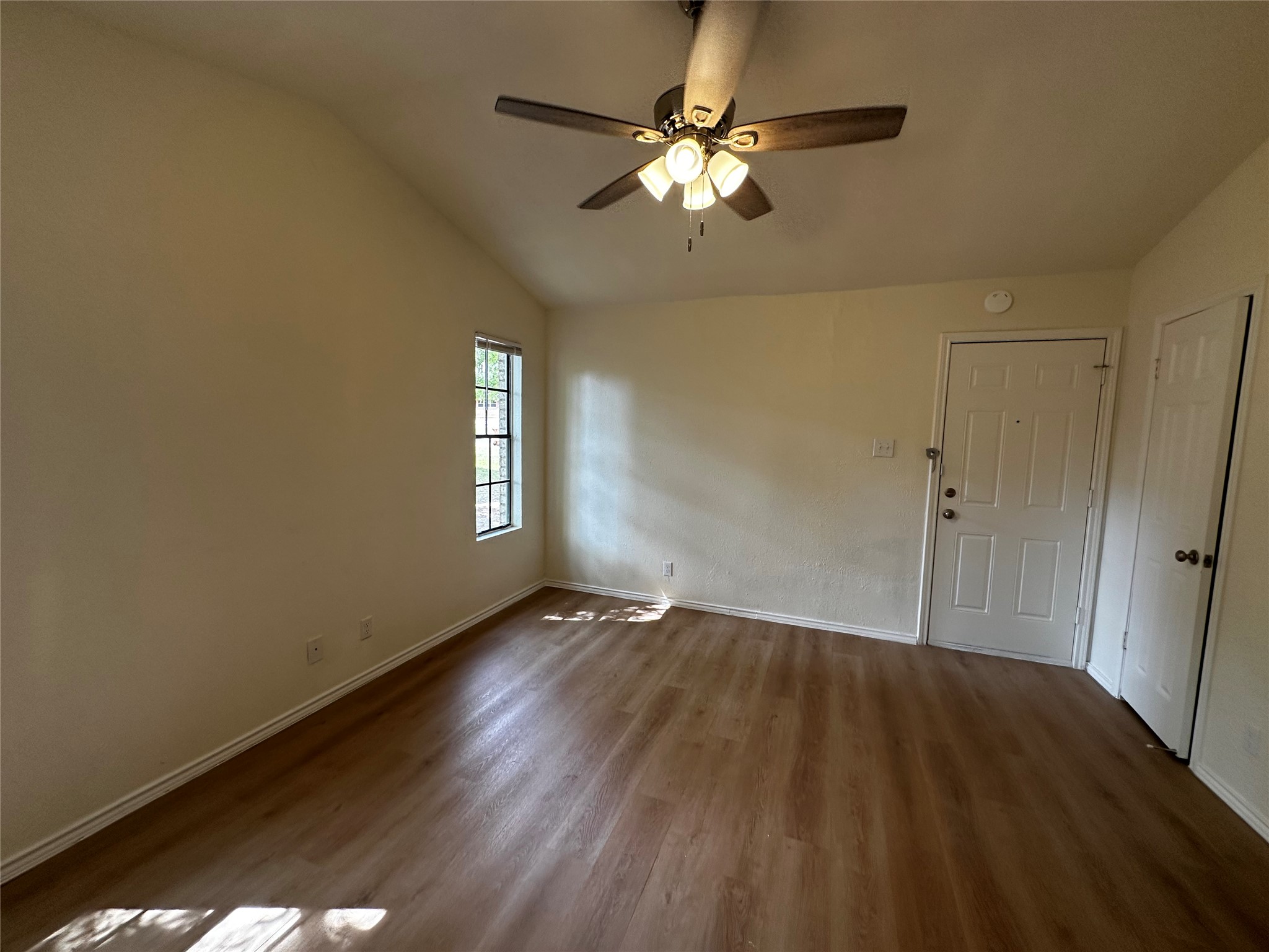 8809 Cainwood Lane Austin, TX 78729 - Photo 18 of 27 a view of an empty room with wooden floor