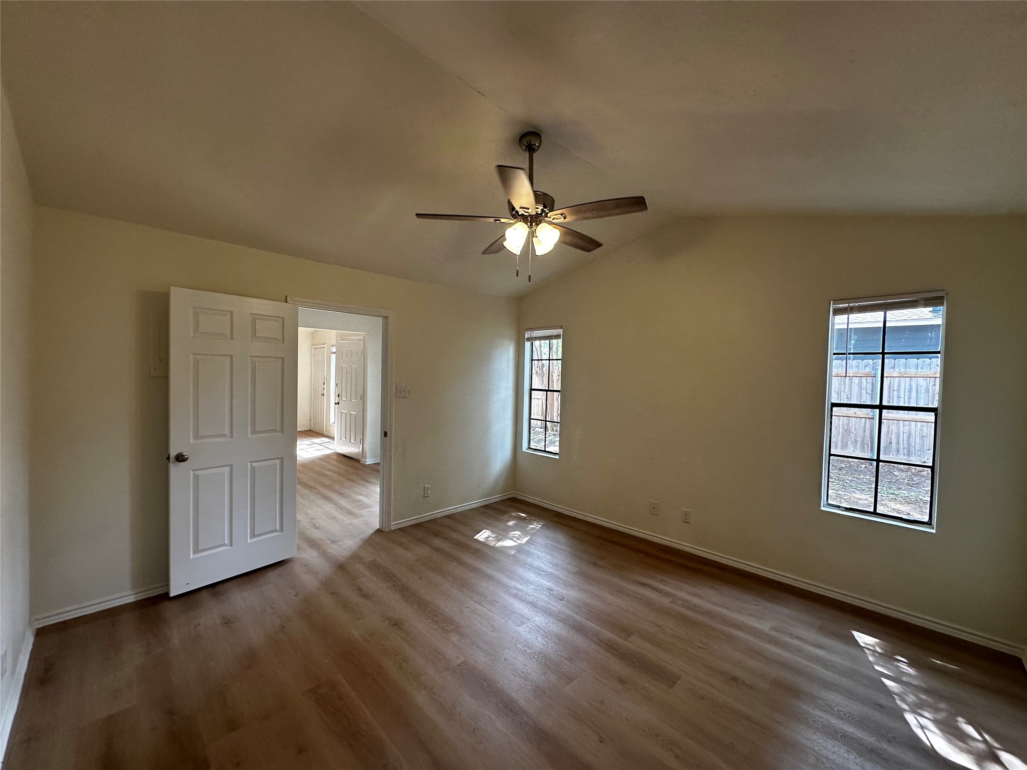 8809 Cainwood Lane Austin, TX 78729 - Photo 19 of 27 a view of an empty room with wooden floor and a window