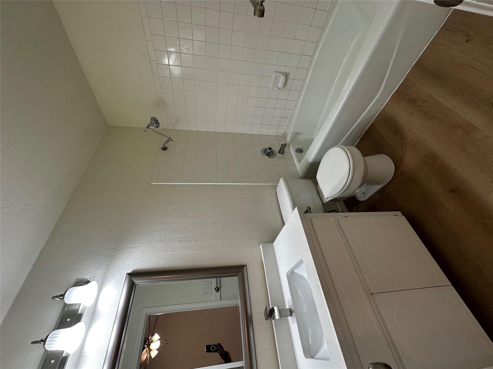 8809 Cainwood Lane Austin, TX 78729 - Photo 20 of 27 a bathroom with a double vanity sink toilet mirror and bathtub