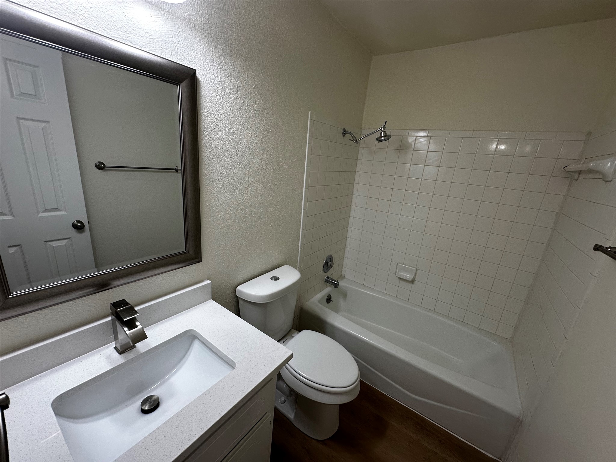8809 Cainwood Lane Austin, TX 78729 - Photo 26 of 27 a bathroom with a sink toilet and shower