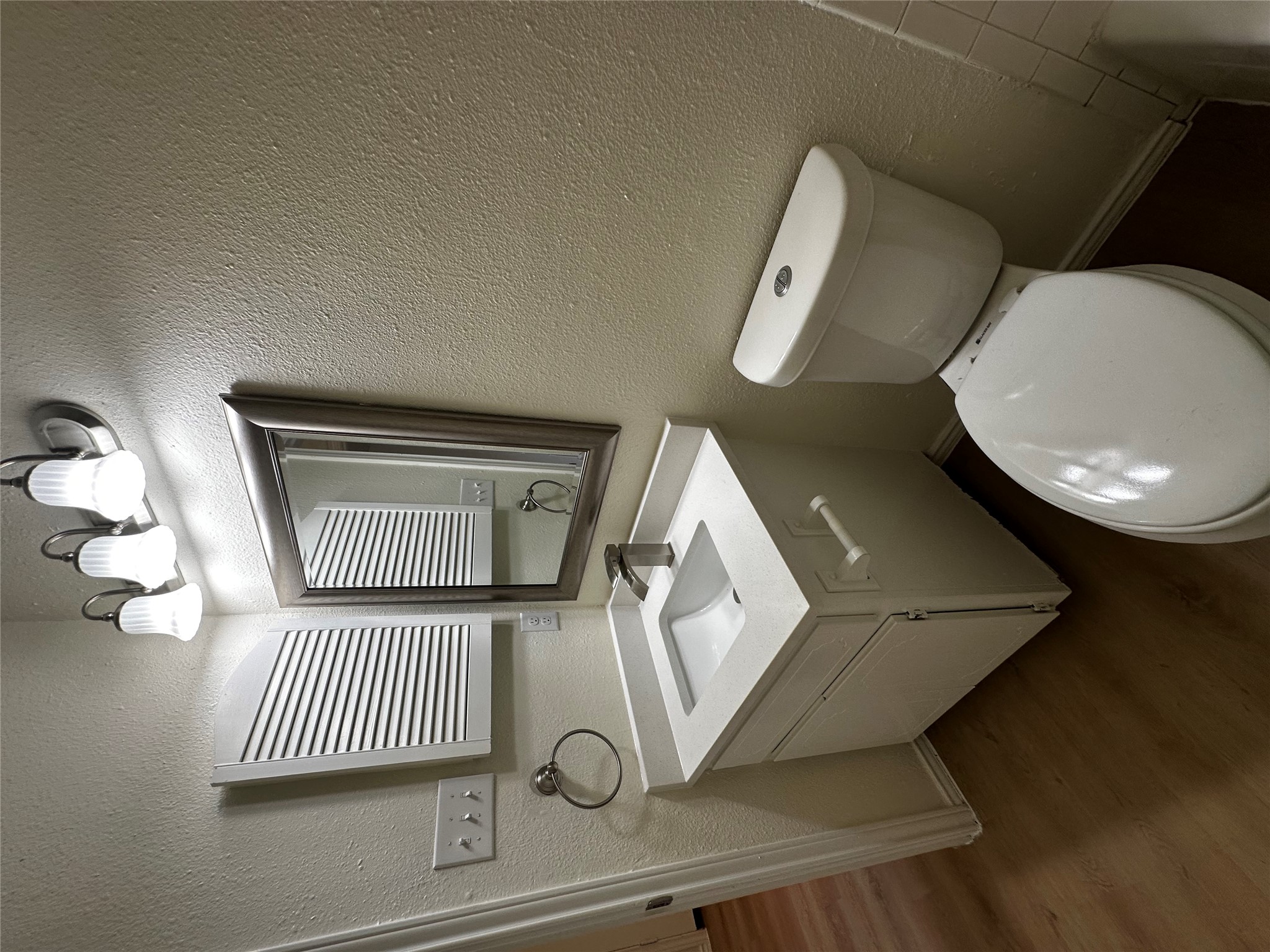 8809 Cainwood Lane Austin, TX 78729 - Photo 27 of 27 a bathroom with a toilet sink and mirror