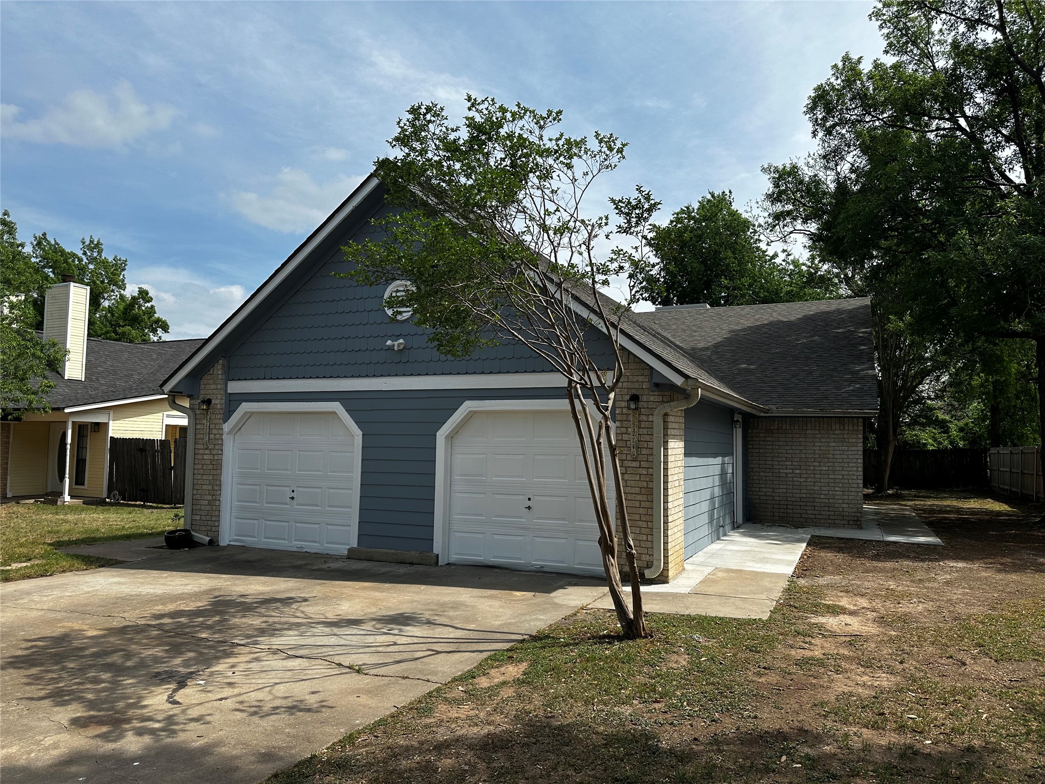 8809 Cainwood Lane Austin, TX 78729 - Photo 4 of 27 a house with a tree in front of it