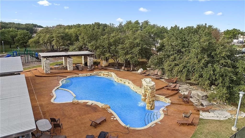 2121 Local Rebel Street Leander, TX 78641 - Photo 16 of 32 Incredible community pool with a gazebo, a patio area, and view of wooded area