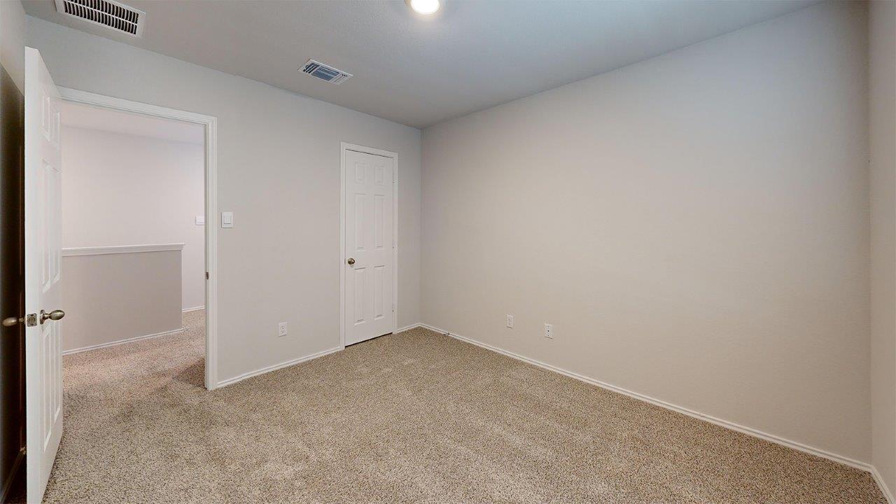 557 Hector Loop Georgetown, TX 78626 - Photo 33 of 38 Carpeted room featuring light gray walls and white trim