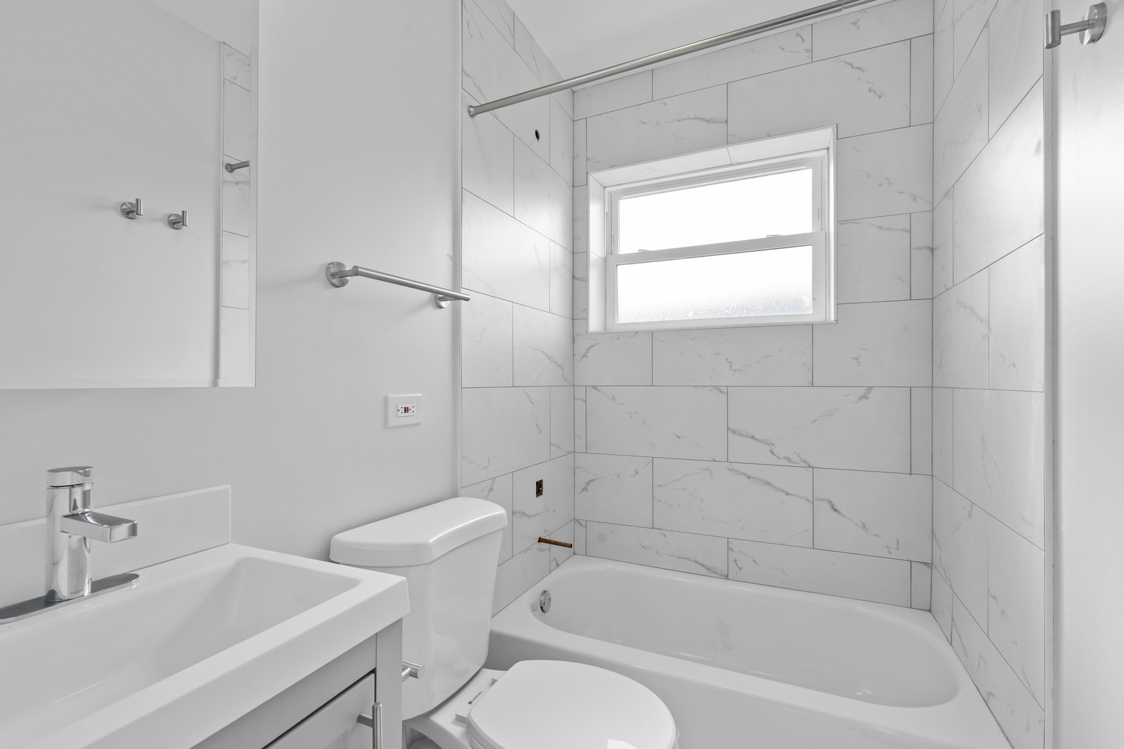 135 Custer Avenue, Unit 3 Evanston, IL 60202 - Photo 11 of 18 a white bath tub sitting next to a white sink and a toilet