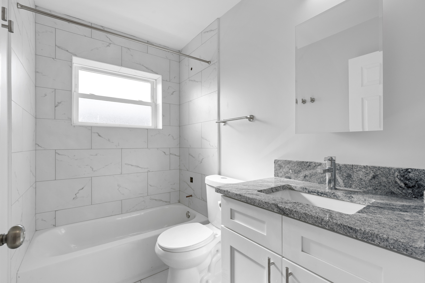 135 Custer Avenue, Unit 3 Evanston, IL 60202 - Photo 12 of 18 a bathroom with a granite countertop sink a toilet and bathtub
