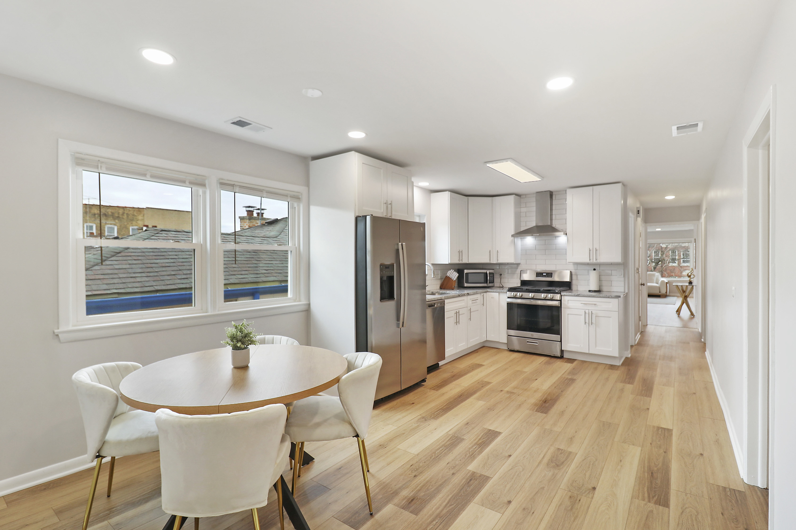 135 Custer Avenue, Unit 3 Evanston, IL 60202 - Photo 3 of 18 a kitchen with a sink a counter space cabinets and stainless steel appliances