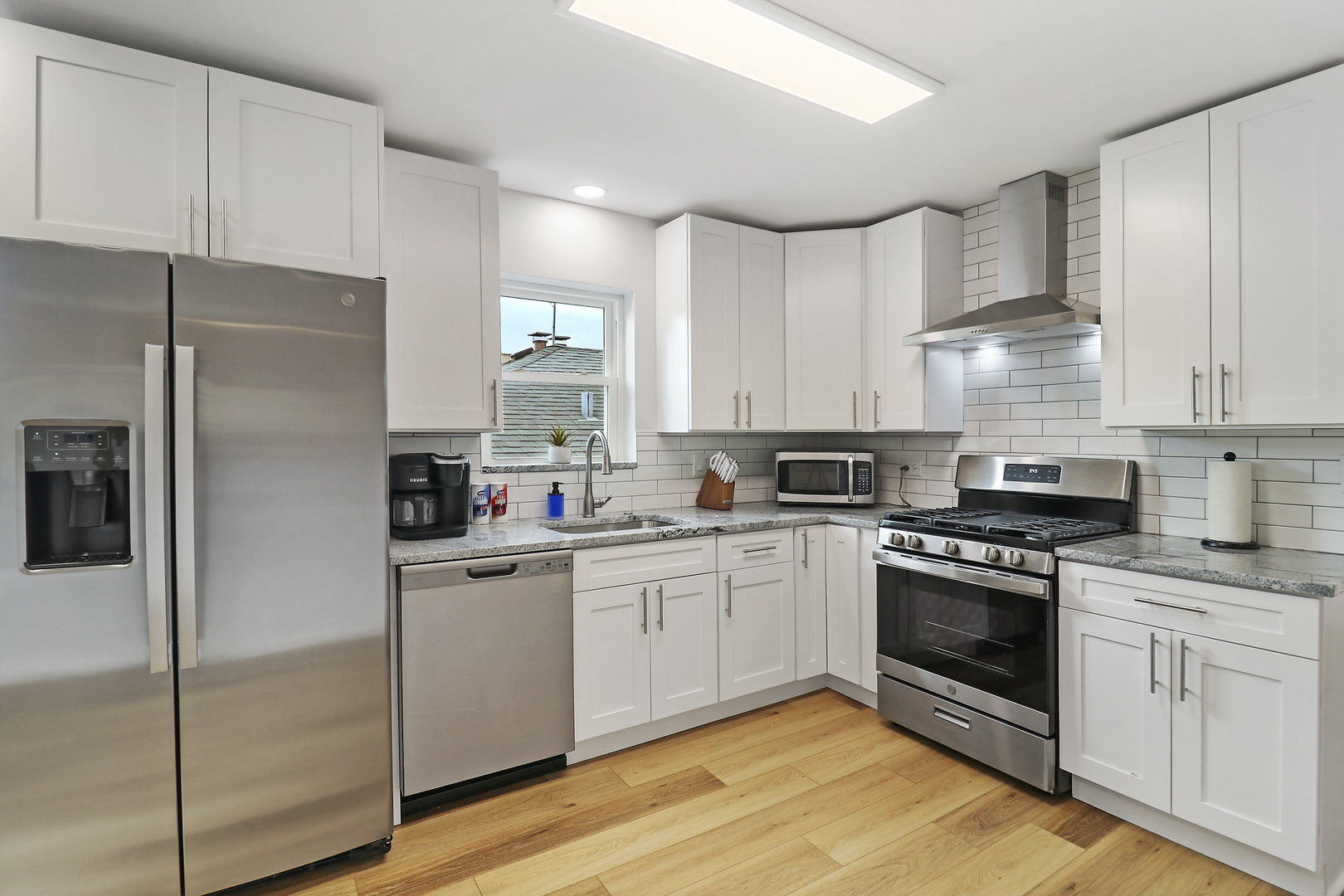 135 Custer Avenue, Unit 3 Evanston, IL 60202 - Photo 4 of 18 a kitchen with cabinets stainless steel appliances and a counter space