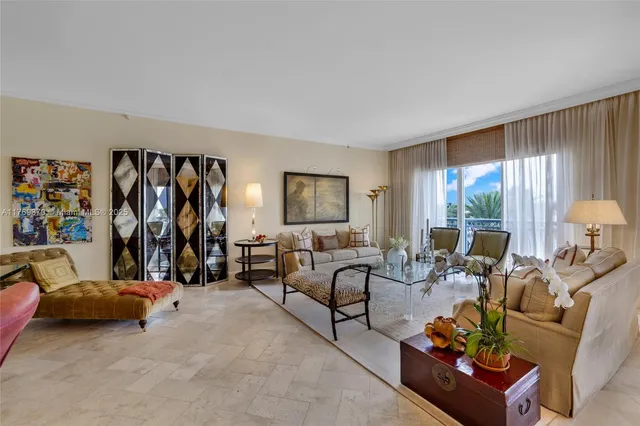 a dining room with furniture a chandelier and a rug