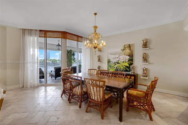 a dining room with furniture and chandelier