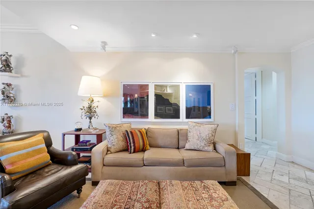 a bedroom with furniture and a flat screen tv