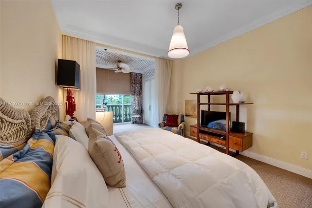 a bedroom with furniture and large windows