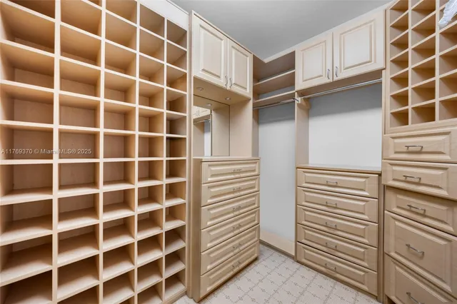a large kitchen with granite countertop a sink and cabinets
