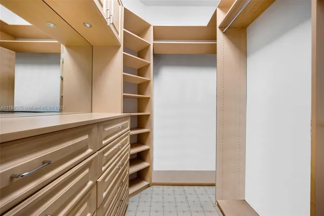a kitchen with granite countertop a sink stove and refrigerator