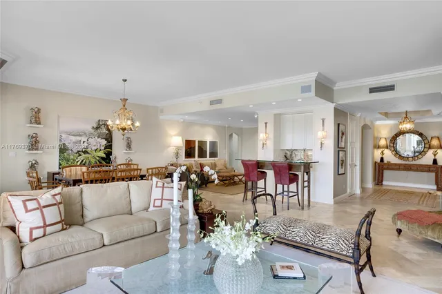 a living room with furniture and a chandelier