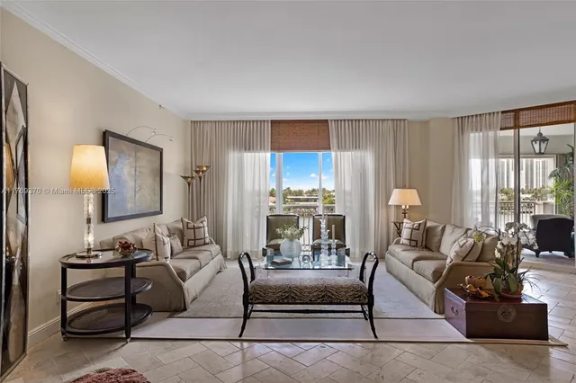 a living room with furniture and large windows