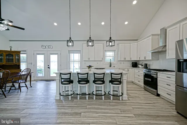 a large kitchen with cabinets table and chairs