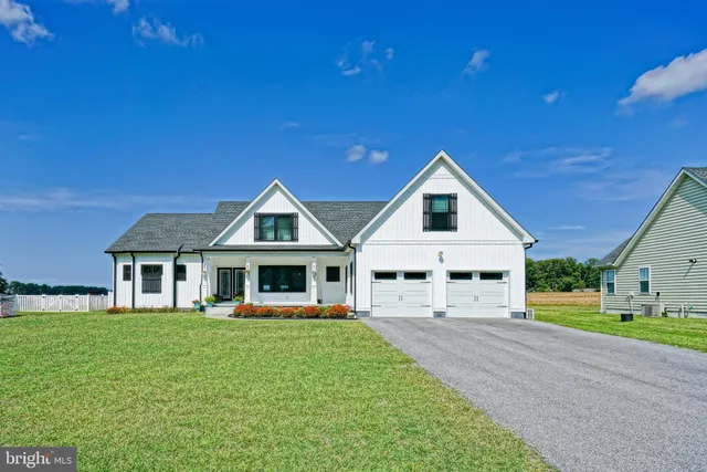 a front view of a house with a yard table and chairs