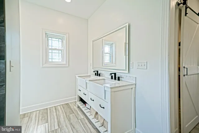 a bathroom with a sink a mirror and a window