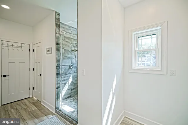 a view of a bathroom with a shower and a window