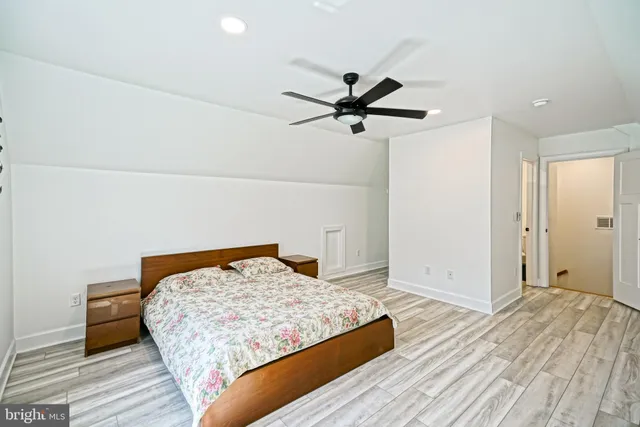 a bedroom with a bed and a painting on the wall