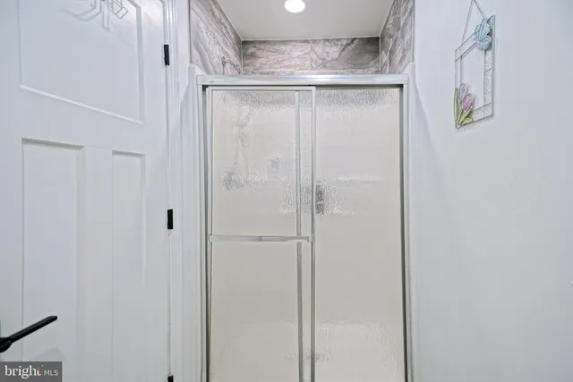 a bathroom with a glass shower door