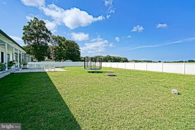 a view of yard with swimming pool and green space