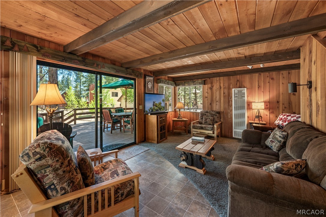 39625 Flicker Road Fawnskin, CA 92333 - Photo 1 of 47 Warm and inviting living room with sliders leading out to a great deck with wide-open views