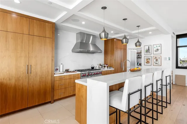 a kitchen with stainless steel appliances granite countertop a stove a refrigerator and a dining table