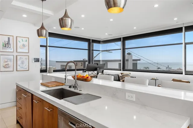 a kitchen with stainless steel appliances a sink and a large window
