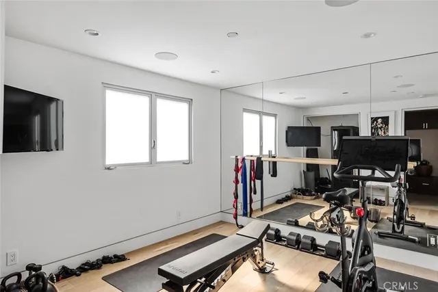 a room with furniture a flat screen tv and a window