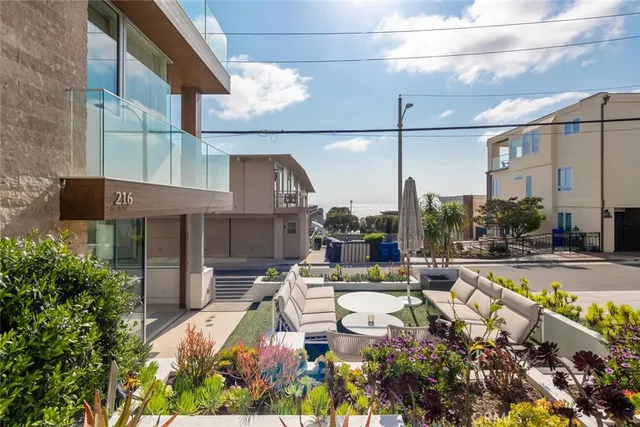 a view of swimming pool with outdoor seating and a potted plant