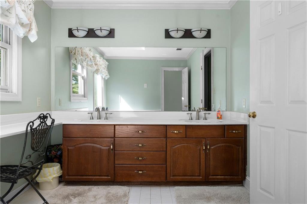 24 Commerce Row Northeast Cartersville, GA 30121 - Photo 21 of 37 a spacious bathroom with a sink and a mirror
