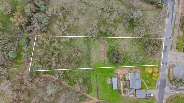 a view of a field with trees