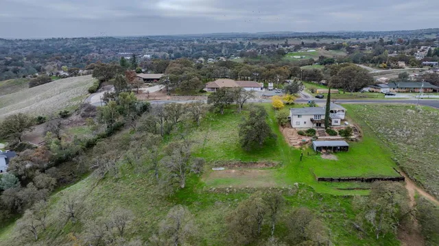 an aerial view of a house with garden space and outdoor seating