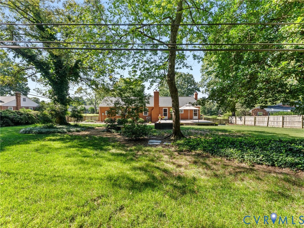 7720 Prairie Road Richmond, VA 23225 - Photo 41 of 49 Expansive green lawn with mature trees, a wooden d