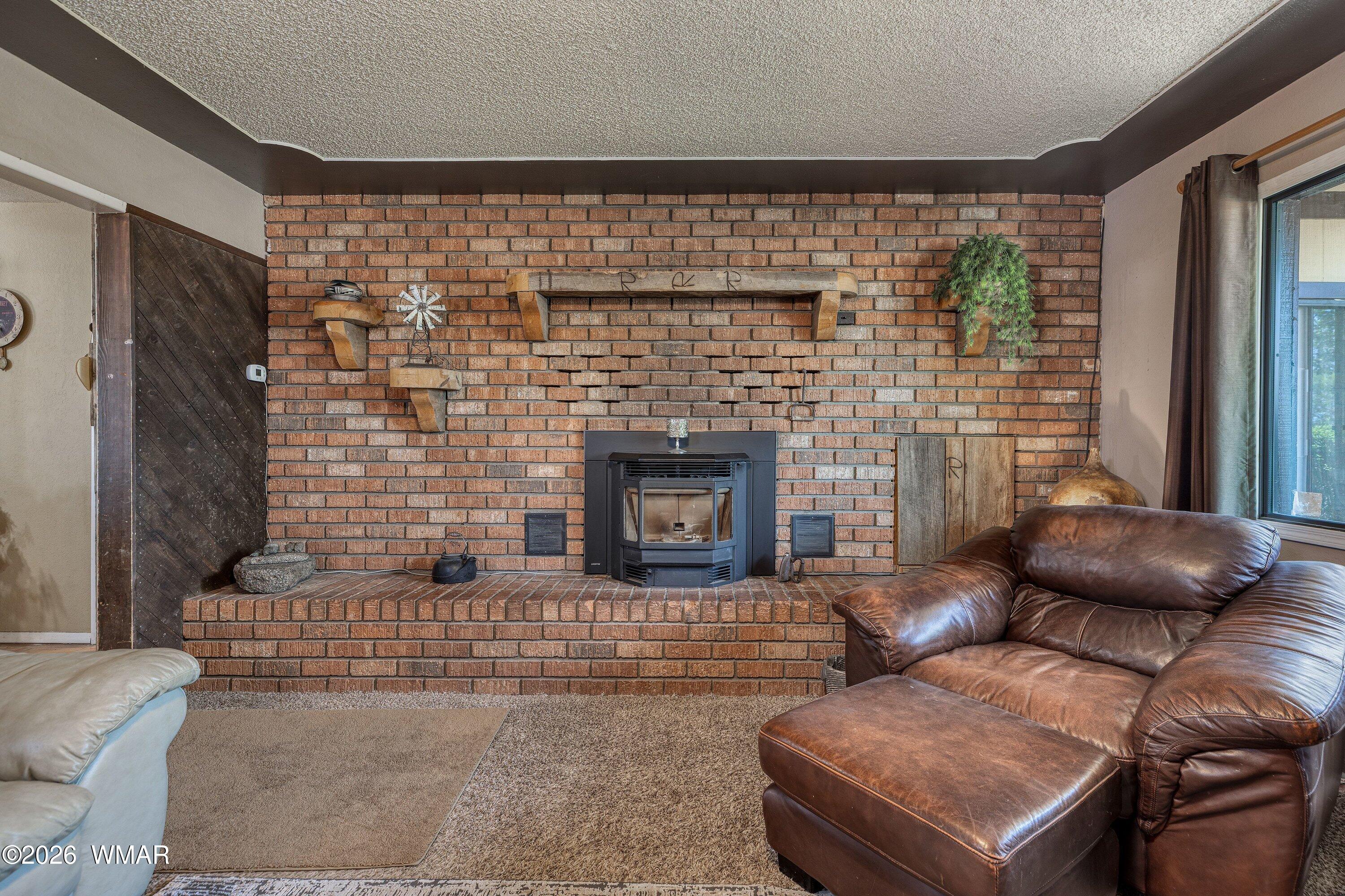 1114 Ranch Road Taylor, AZ 85939 - Photo 15 of 32 a living room with furniture and a fireplace