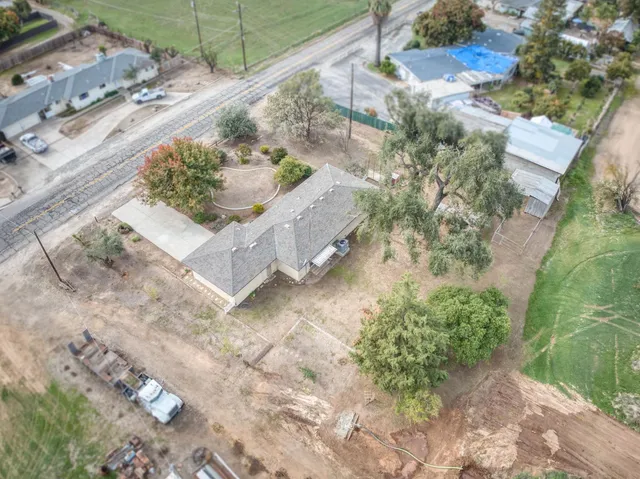 an aerial view of a house with a yard